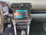 a car dashboard with a radio and a steering wheel