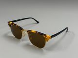 a close up of a pair of sunglasses on a white surface