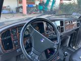 a dashboard and steering wheel of a car in a garage