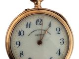 a close up of a gold pocket watch with numbers on it