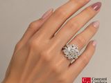 woman ' s hand with a diamond ring and a diamond engagement ring