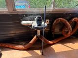 a hose attached to the side of a window sill