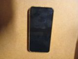 an iphone is sitting on top of a cardboard box on a table
