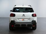 the rear end of a white citrole parked in a room