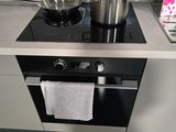 a stove with a pot on top of it in a kitchen