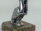 statue of a pelican sitting on a marble base