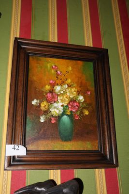a painting of flowers in a vase on the wall