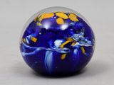 a blue glass ball with yellow and blue flowers on it
