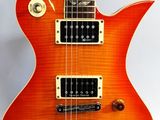 an orange electric guitar sitting on top of a white surface