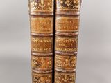 a pair of old books sitting on top of each other