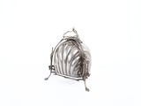 an antique silver plated toaster with a shell design on the front