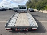 a picture of a flatbed truck parked in a parking lot
