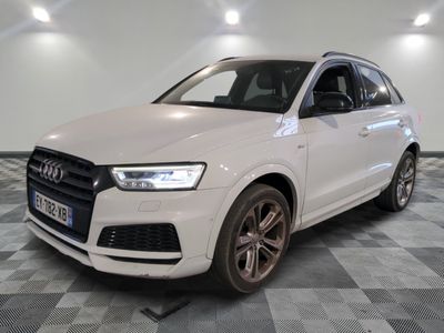 the white audi q3 is parked on a checkered floor