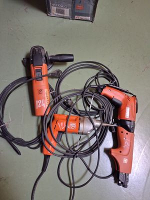 two electric tools that are laying on the floor