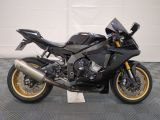a picture of a black motorcycle parked on a checkered floor