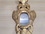 a mirror on the wall in the shape of a fish