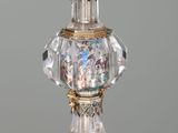 a crystal vase with a gold base and a glass top