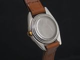 an image of a close up of a watch on a black background