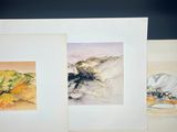 three watercolor paintings of mountains and trees on a black background