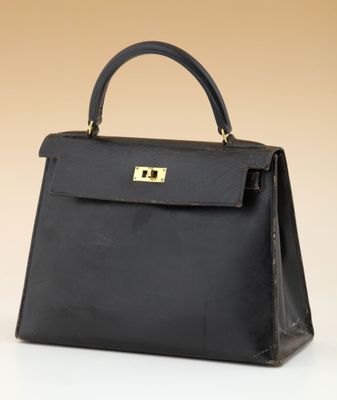 a black leather handbag on a white surface