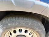 a close up of a car ' s tire with holes in it