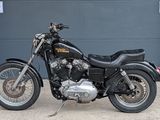 a black motorcycle parked in front of a garage door