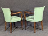 pair of mid - century style chairs with green upholstered upholstered seats