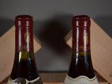 two bottles of wine that are sitting on a table