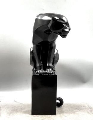 statue of a black cat sitting on a black block