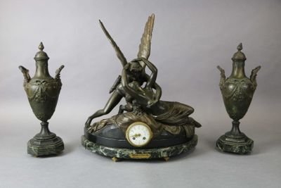 a clock sitting on top of a table next to two vases and a clock