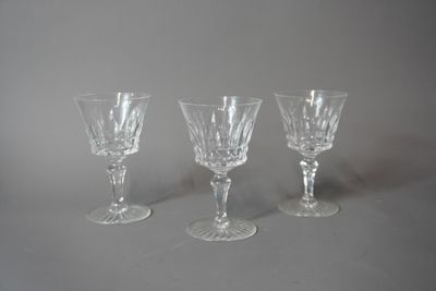 trois verres à vin transparents sont alignés sur une surface grise