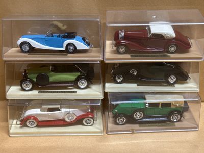 four different models of cars in a display case
