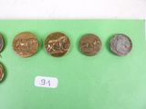 five different types of coins sitting on a green surface