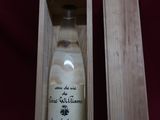 an empty bottle of wine in a wooden box on a red cloth