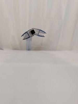 un gros plan sur un lit aux draps blancs, au-dessus duquel vole un oiseau