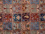 an old persian rug with many different colors and patterns
