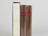 two books sitting next to each other on a white surface