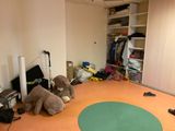 a teddy bear that is sitting on the floor in the room