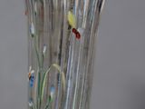 a glass vase with flowers and butterflies painted on it