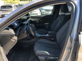 the interior of a car with the door open and the driver ' s seat down