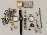 a lot of assorted items that include a watch, bracelets, keys, and other items
