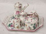 a tray with a tea set on it on a white table