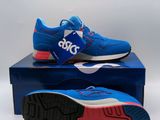 a pair of blue sneakers sitting on top of a blue box