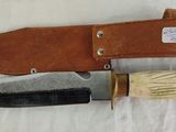 a knife that is laying on a white cloth