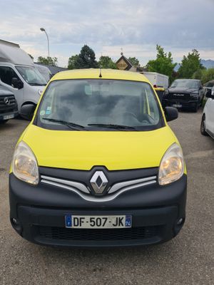 yellow and black van parked in a parking lot next to other cars