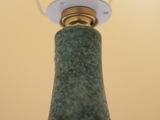 a light that is on top of a green pole