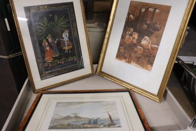 two framed pictures on a table next to each other