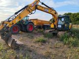a picture of a tractor and a dump truck in a field