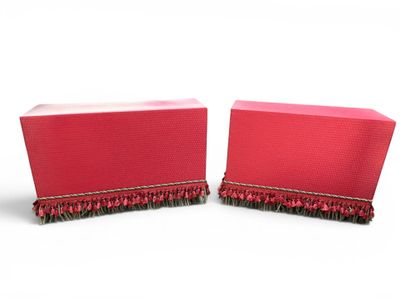 pair of red boxes with ruffled edges on a white background