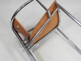 a metal and wood magazine rack with a magazine holder on it